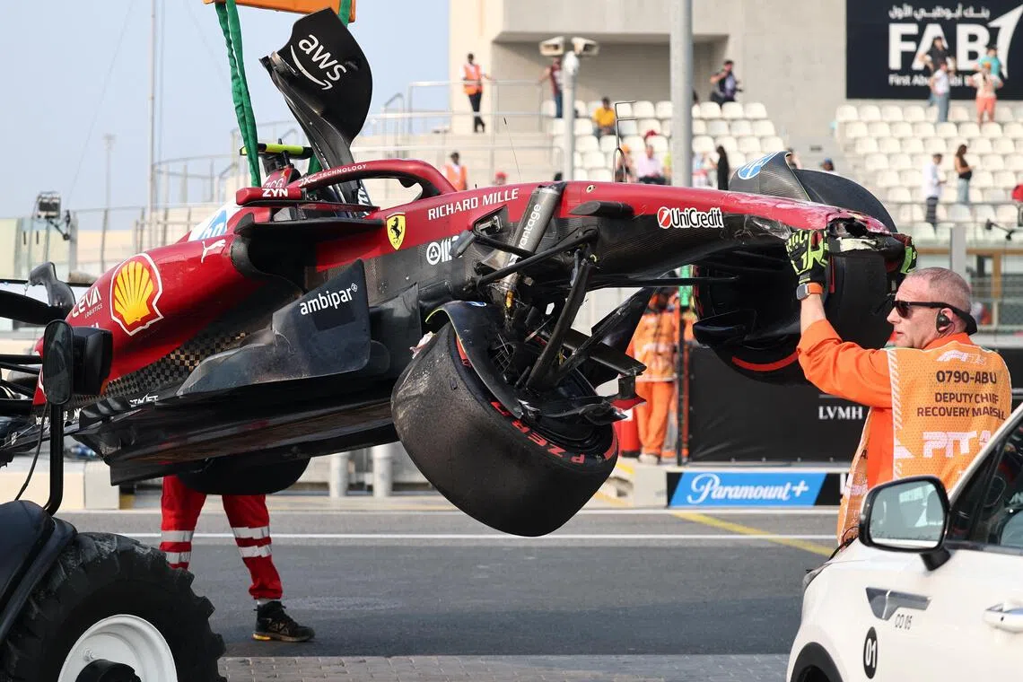Stewards retrieving the car of Ferrari's Lewis Hamilton after his crash during practice.