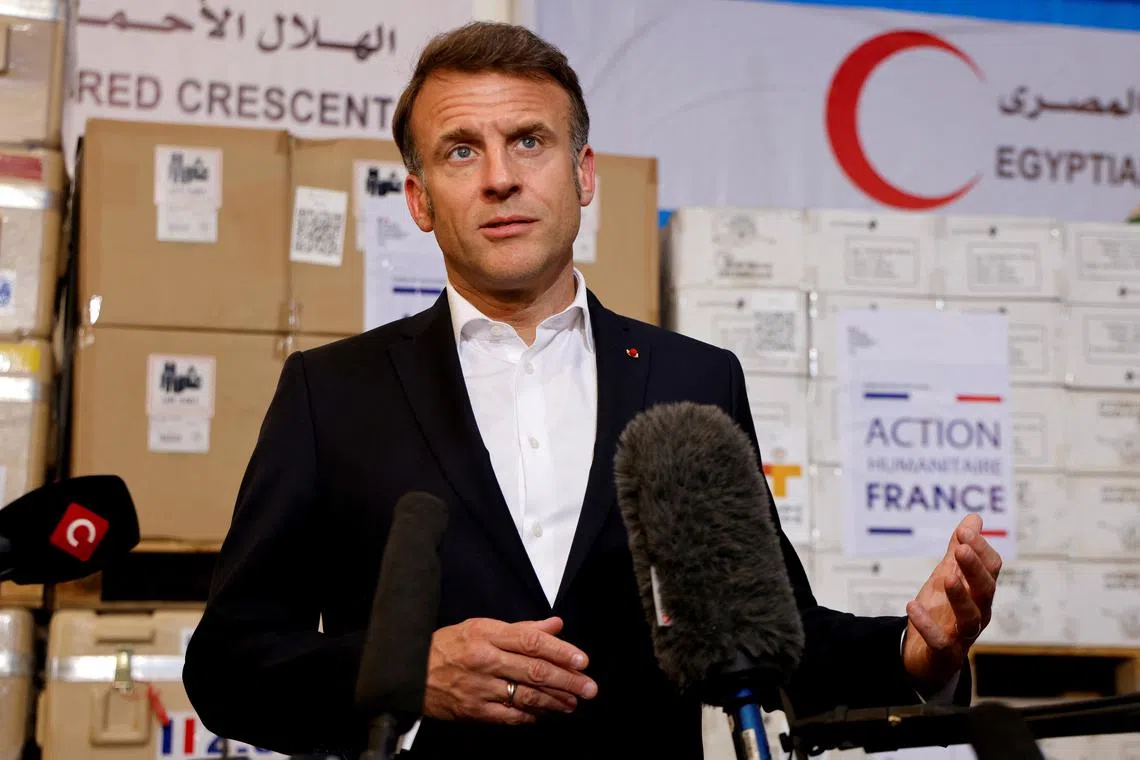 France's President Emmanuel Macron speaks in front of humanitarian aid destined to Gaza, at the Egyptian Red Crescent warehouse in Arish, Egypt April 8, 2025. Ludovic Marin/Pool via REUTERS