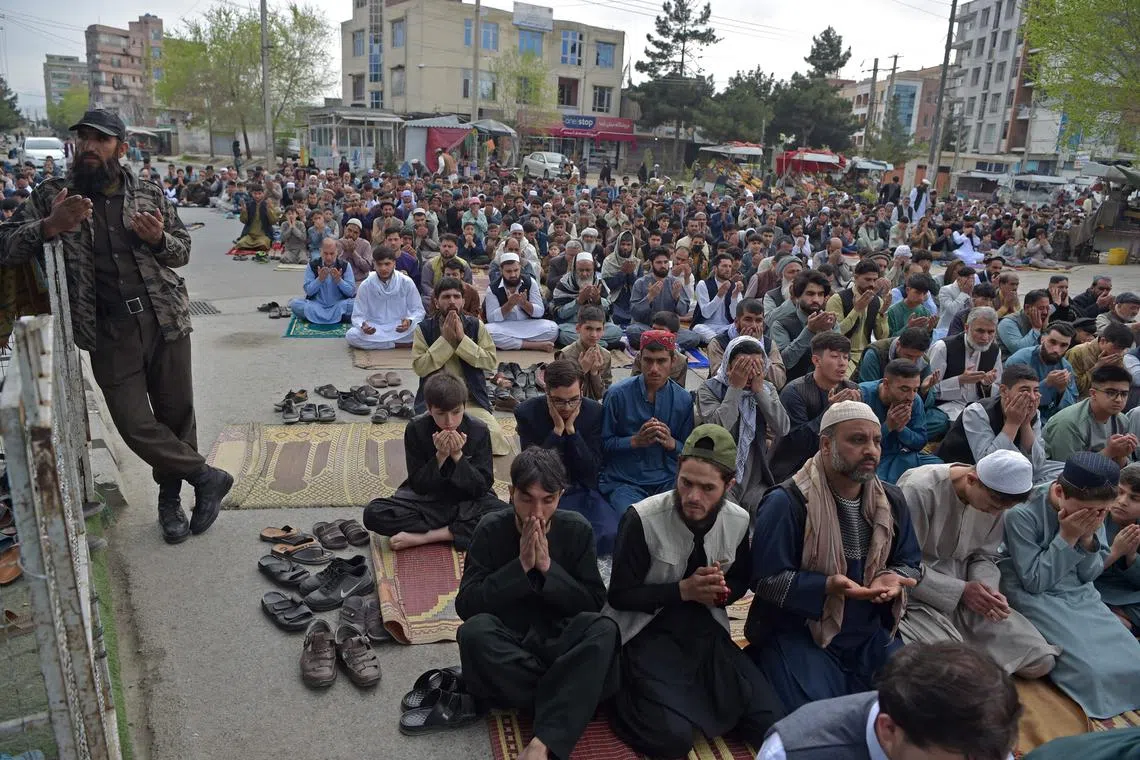 Muslim devotees offer Eid al-Fitr prayers, marking the end of the holy month of Ramadan, in Kabul.