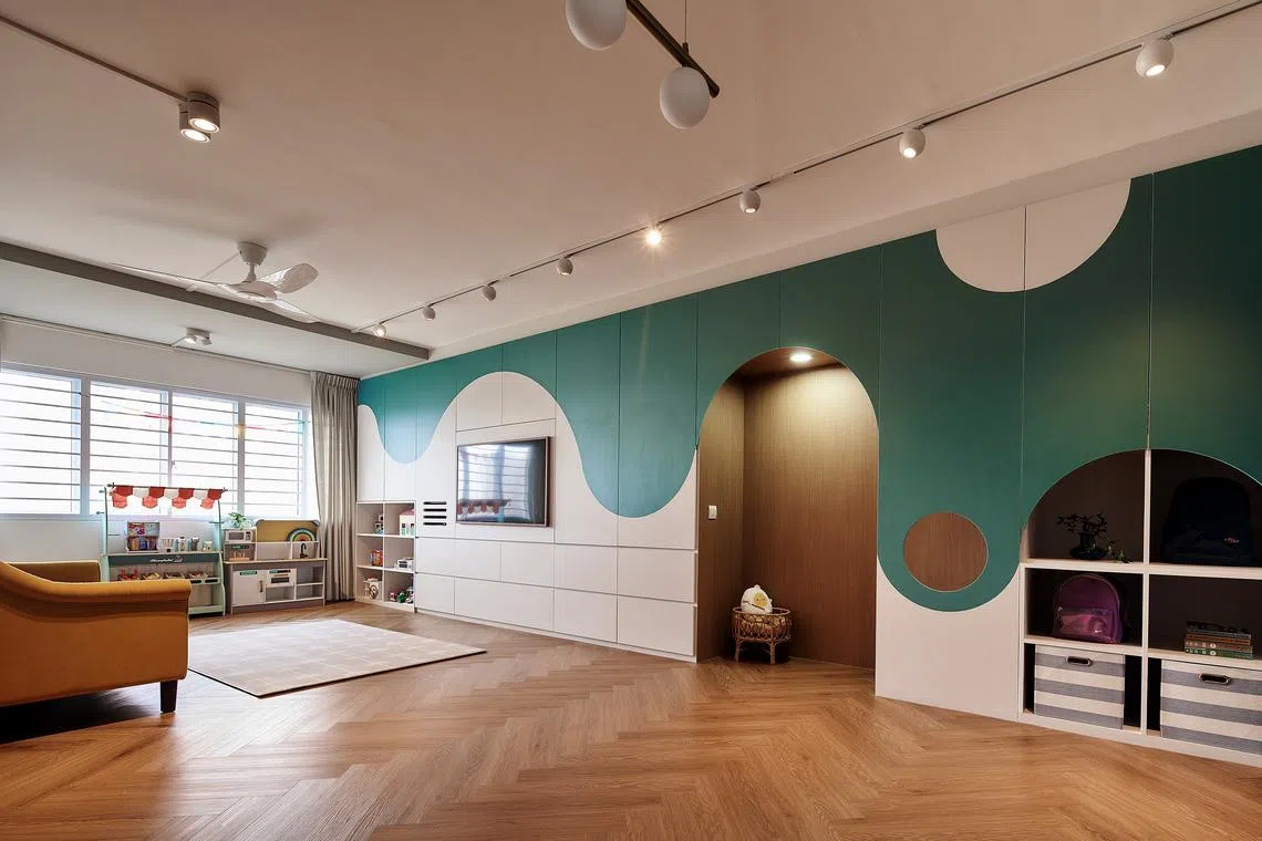 The living area has plenty of space for the kids to play. The only ceiling features here are track lights, creating an airy feel. 