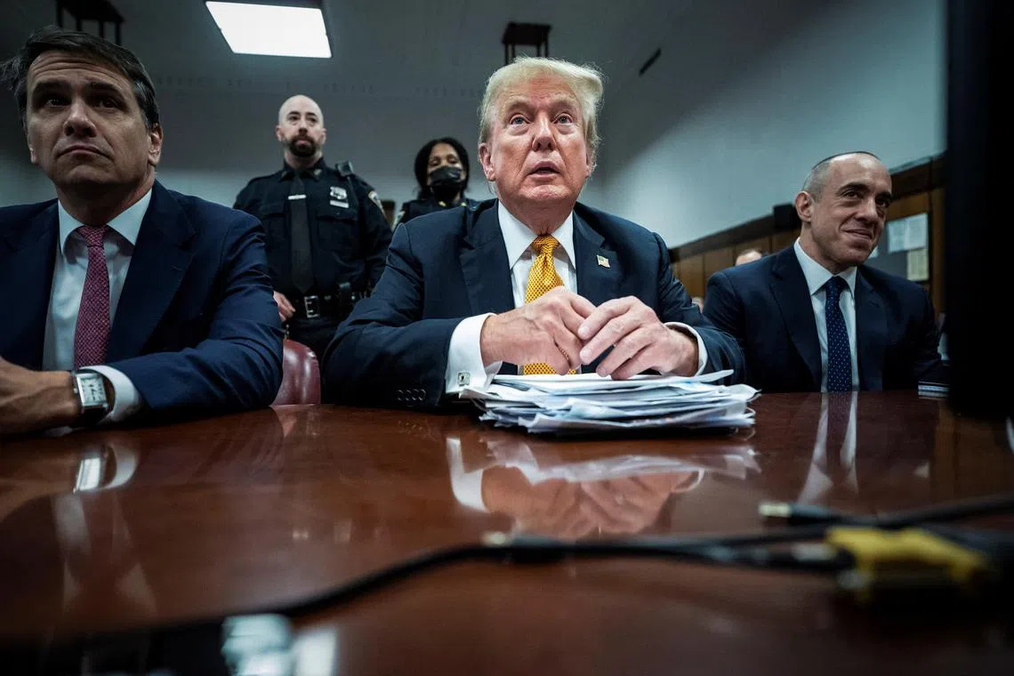 Former U.S. President Donald Trump, flanked by attorneys Todd Blanche and Emil Bove, arrives for his criminal trial at the Manhattan Criminal Court in New York, NY on Wednesday, May 29, 2024. Trump was charged with 34 counts of falsifying business records last year, which prosecutors say was an effort to hide a potential sex scandal, both before and after the 2016 presidential election. Trump is the first former U.S. president to face trial on criminal charges.  Jabin Botsford/Pool via REUTERS