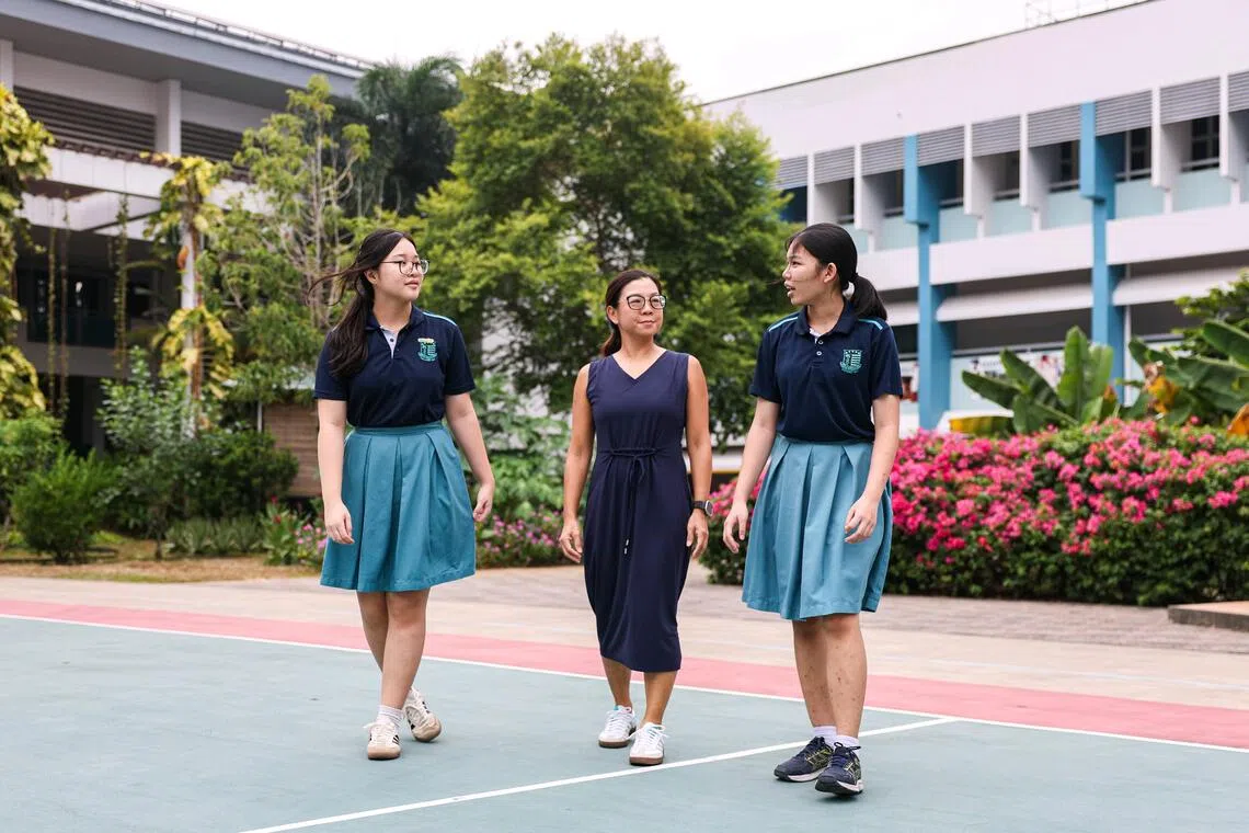 Swiss Cottage Secondary School principal Mandy Cheng (centre) with students Natasha Ng (left) and Andi’ Syakirah (right) on Sept 18.
