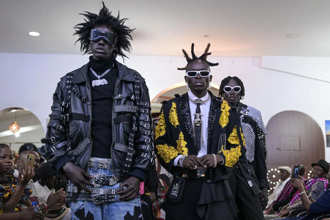 Models present creations by Kenyan designer Morgan Azedy during the main fashion show during the Africa Fashion Week, at the delight technical college in Nairobi on Dec 9.