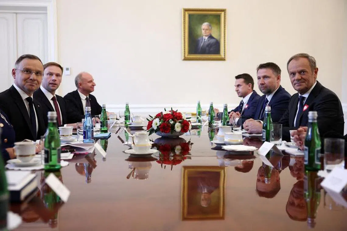 FILE PHOTO: Polish President Andrzej Duda (L) meets with leaders of Civic Coalition  Donald Tusk, Adam Szlapka and Marcin Kierwinski during consultations with leaders of the two main parties; Law and Justice and Civic Platform, in the newly elected parliament, at the Presidential Palace in Warsaw, Poland, October 24, 2023. REUTERS/Kacper Pempel/File Photo