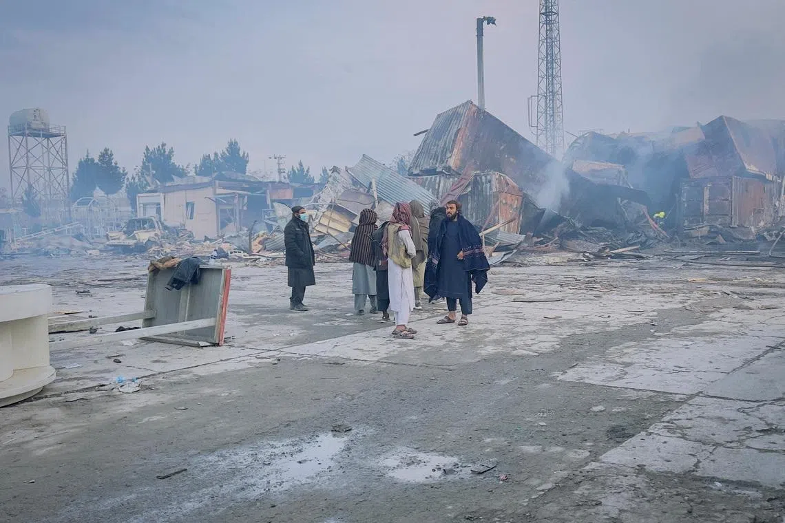People stand next to a drug users rehabilitation hospital destroyed in what the Taliban said was a Pakistani air strike, in Kabul, Afghanistan, March 17, 2026. REUTERS/Sayed Hassib