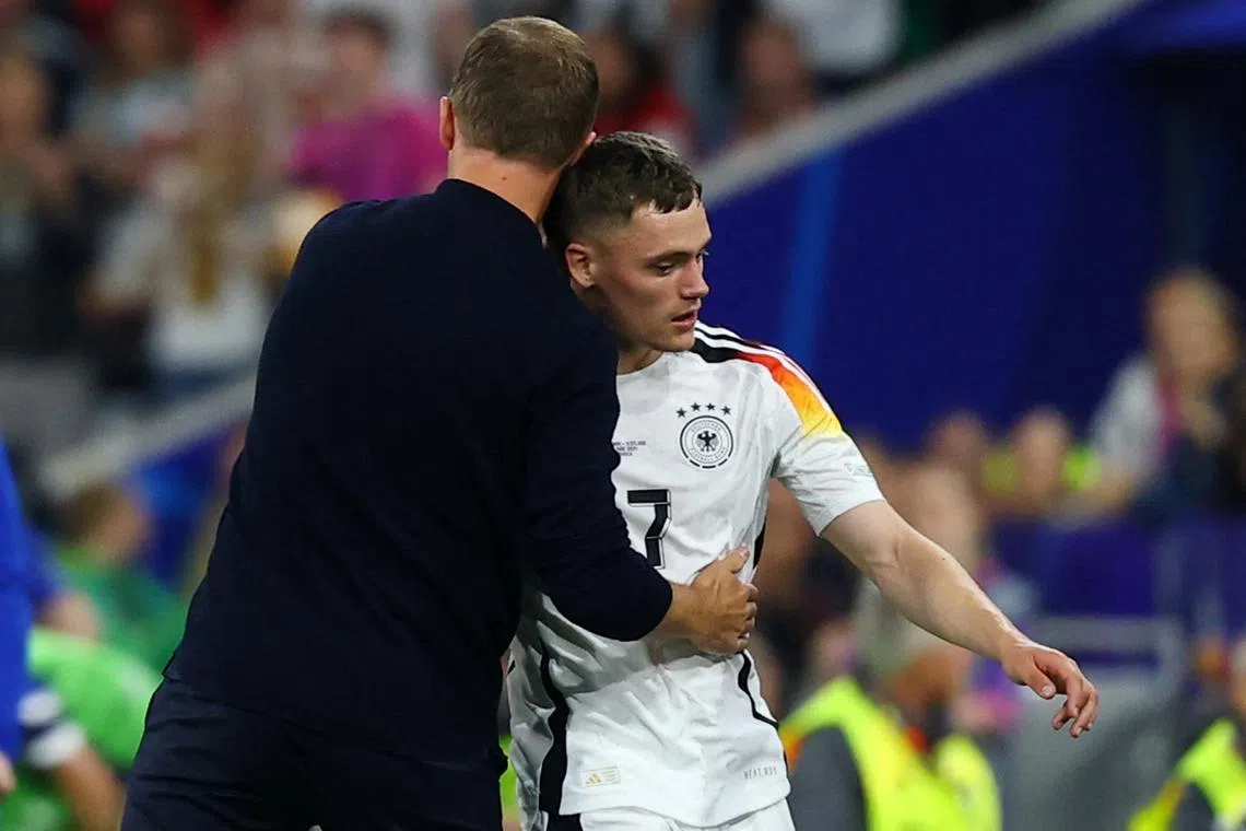 Soccer Football - Euro 2024 - Group A - Germany v Scotland - Munich Football Arena, Munich, Germany - June 14, 2024  Germany's Florian Wirtz with coach Julian Nagelsmann after being substituted REUTERS/Kai Pfaffenbach