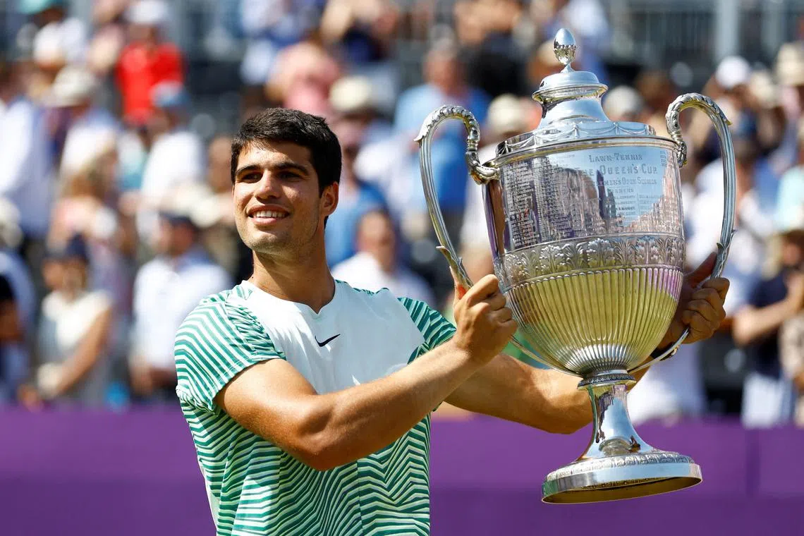 FILE PHOTO: Tennis - ATP 500 - Queen's Club Championships - Queen's Club, London, Britain - June 25, 2023 Spain's Carlos Alcaraz celebrates with the trophy after winning his final match against Australia's Alex de Minaur Action Images via Reuters/Peter Cziborra