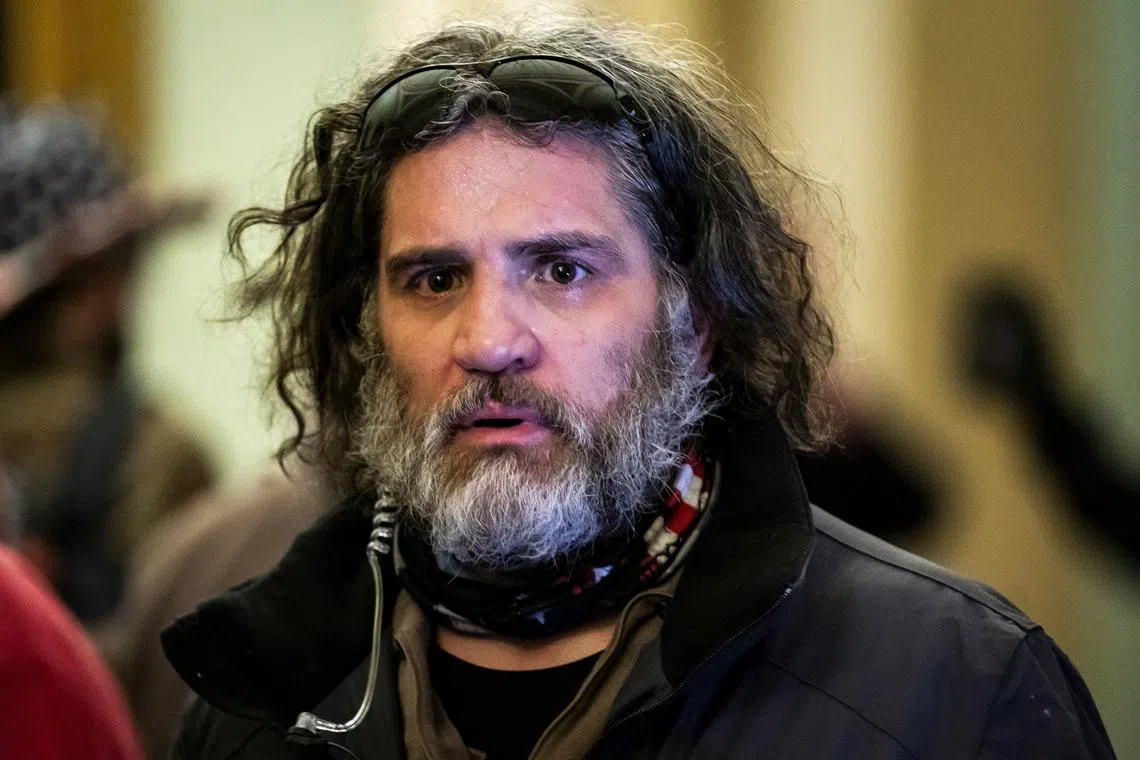 A 2021 photo shows Dominic Pezzola confronting police at the US Capitol shortly after using a stolen police riot shield to smash through a Capitol window.