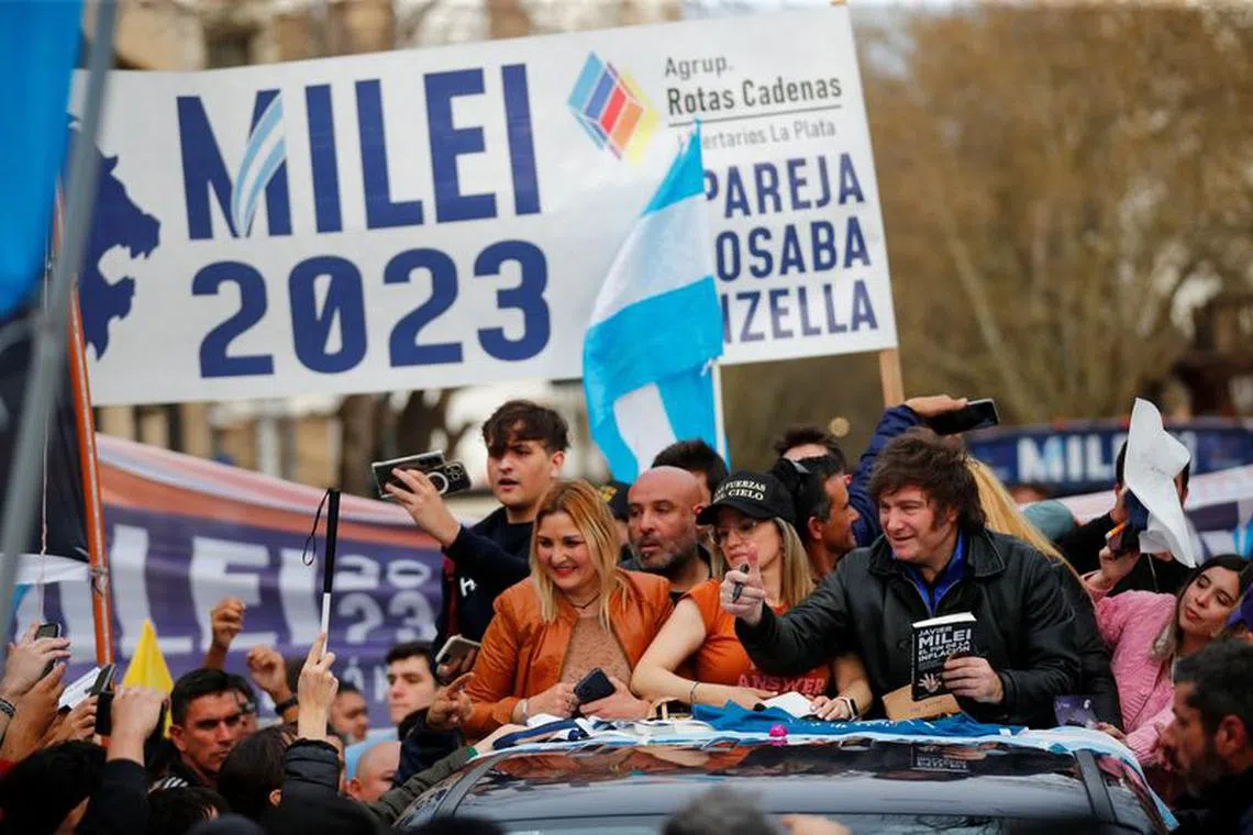 Argentine presidential candidate Javier Milei for La Libertad Avanza coalition gestures next to Carolina Piparo, candidate for Governor of the Province of Buenos Aires, during a campaign rally in La Plata, Buenos Aires, Argentina, September 12, 2023. REUTERS/Agustin Marcarian/File photo