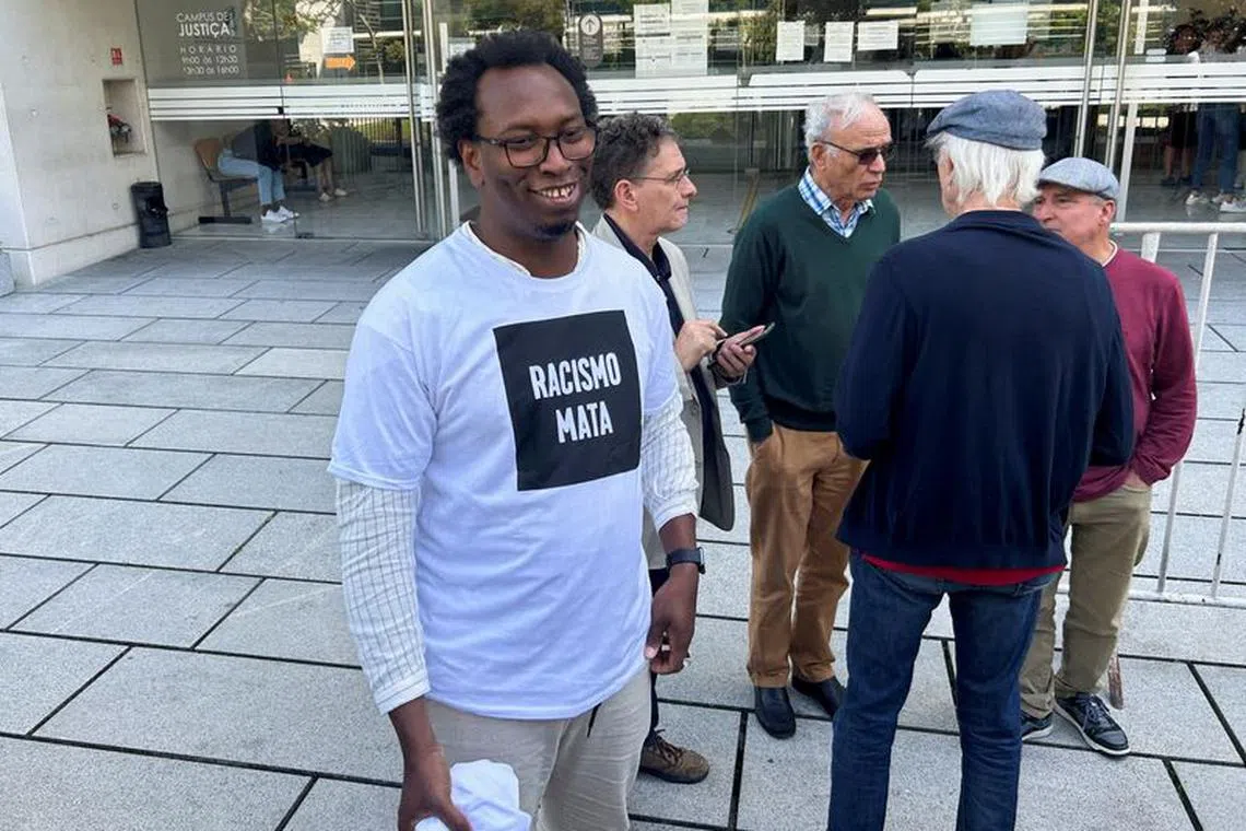 FILE PHOTO: Anti-racism activist Mamadou Ba smiles, while wearing a shirt that reads \"Racism kills\", after the first hearing of his defamation trial, outside a court in Lisbon, Portugal, May 10, 2023. REUTERS/Catarina Demony/File Photo