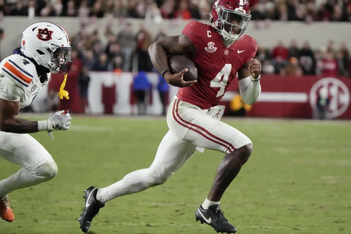 Nov 30, 2024; Tuscaloosa, Alabama, USA;  Alabama Crimson Tide quarterback Jalen Milroe (4) runs for a touchdown against Auburn Tigers cornerback Kayin Lee (4) during the second half at Bryant-Denny Stadium. Alabama won 28-14. Mandatory Credit: Gary Cosby Jr.-Imagn Images/ File Photo