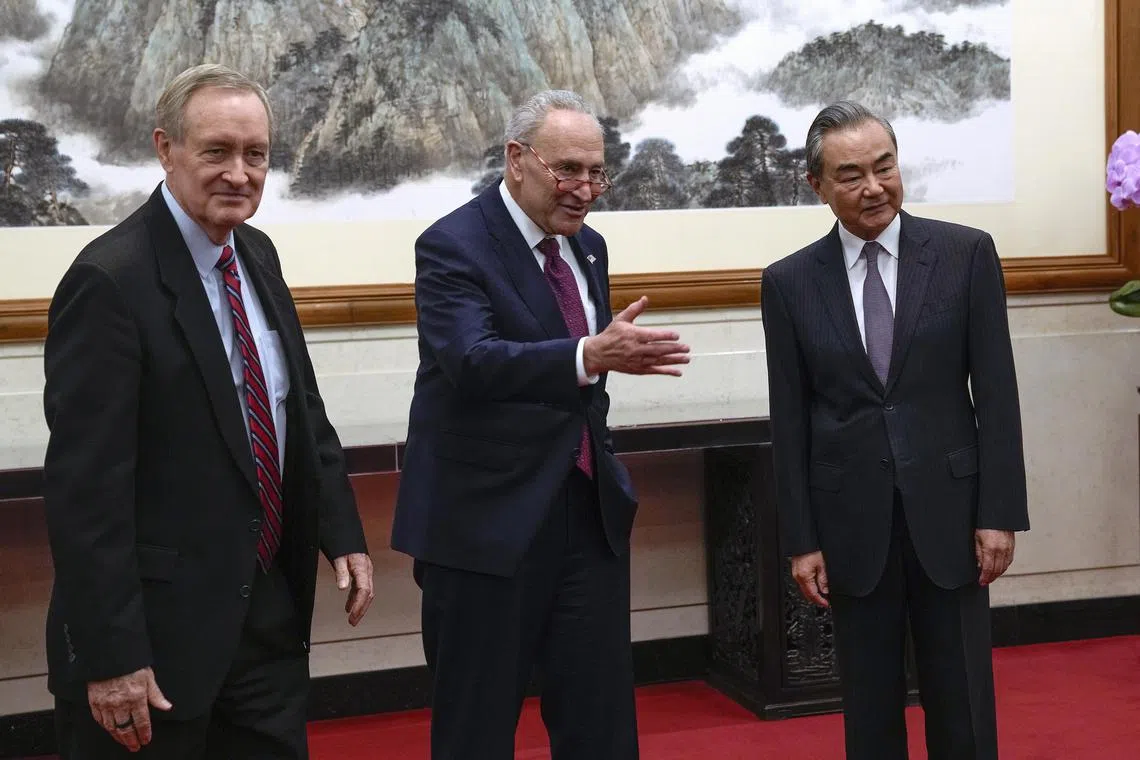 From left: US Senator Mike Crapo, US Senate Majority Leader Chuck Schumer and Chinese Foreign Minister Wang Yi at the Diaoyutai Guest House in Beijing on Oct 9, 2023.