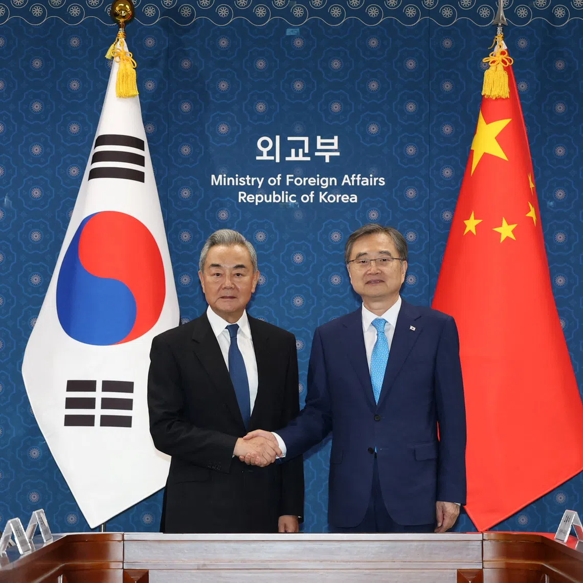 Chinese Foreign Minister Wang Yi (left) shakes hands with his South Korean counterpart Cho Hyun during their meeting at the Foreign Ministry in Seoul, on Aug 19.