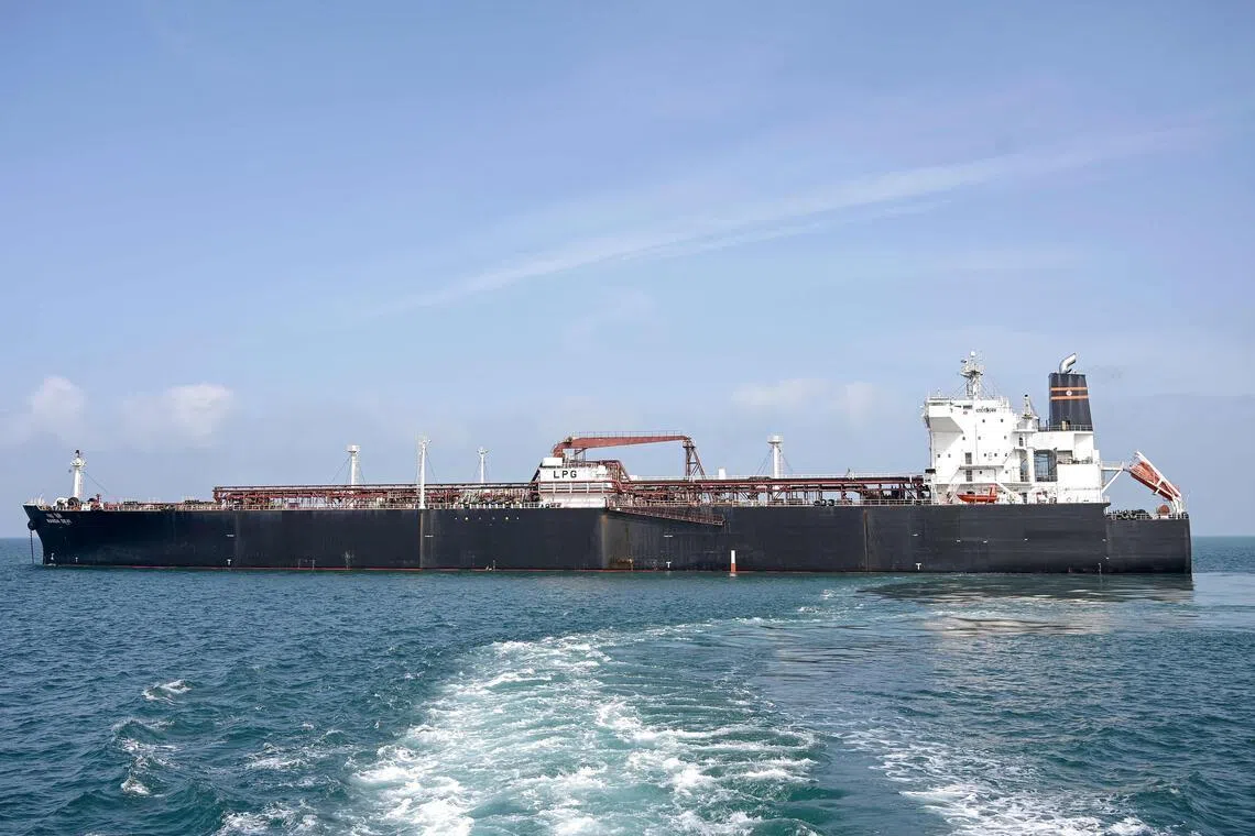 TOPSHOT - Indian vessel 'Nanda Devi' carrying liquefied petroleum gas (LPG) arrives at Vadinar Port in the Jamnagar district of Gujarat state on March 17, 2026 after Iran allowed it to pass through the Strait of Hormuz, a key energy corridor that remains disrupted by the Middle East war. Indian-flagged tankers 'Shivalik' and 'Nanda Devi', carrying around 92,700 metric tonnes of LPG, had reached ports in Gujarat state, marking a rare exception in commercial passage through the chokepoint. (Photo by AFP)