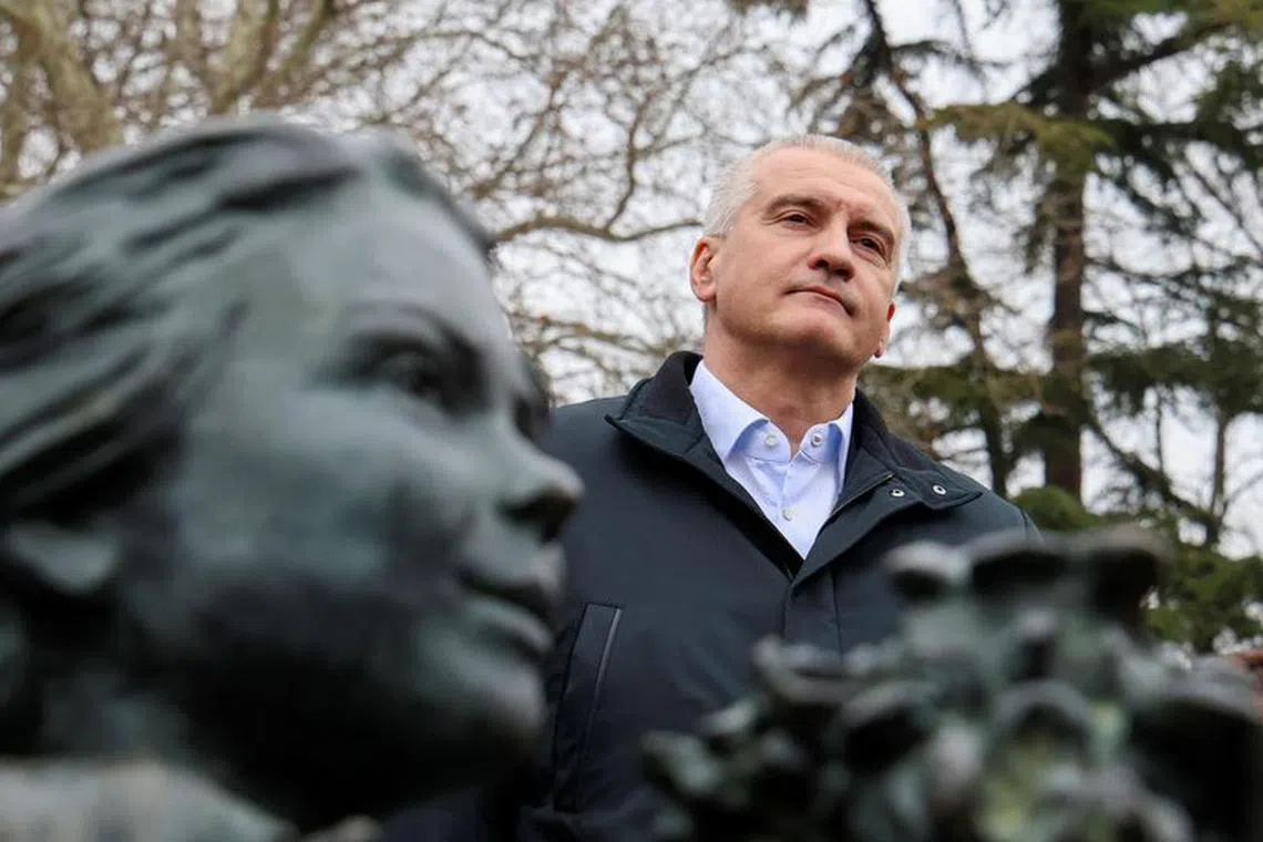 Russian governor of Crimea Sergei Aksyonov takes part in a ceremony marking the ninth anniversary of the Crimean referendum at the monument to the so-called \"Polite People\" or the Russian service members, who enhanced security during Russia's annexation of Crimea, in Simferopol, Crimea, March 16, 2023. REUTERS/Alexey Pavlishak/file photo