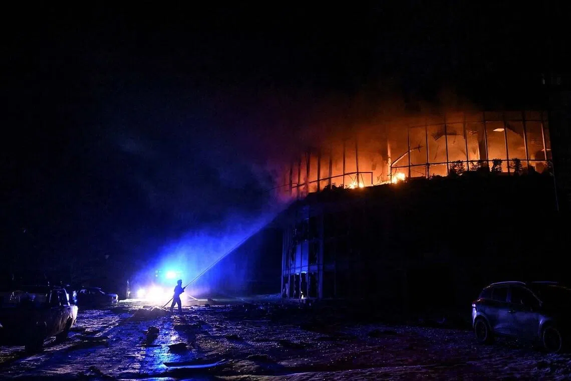 A firefighter working at the site of a residential complex damaged during an overnight Russian drone strike, amid Russia's attack on Ukraine, in Zaporizhzhia, Ukraine, Jan 2, 2026. 