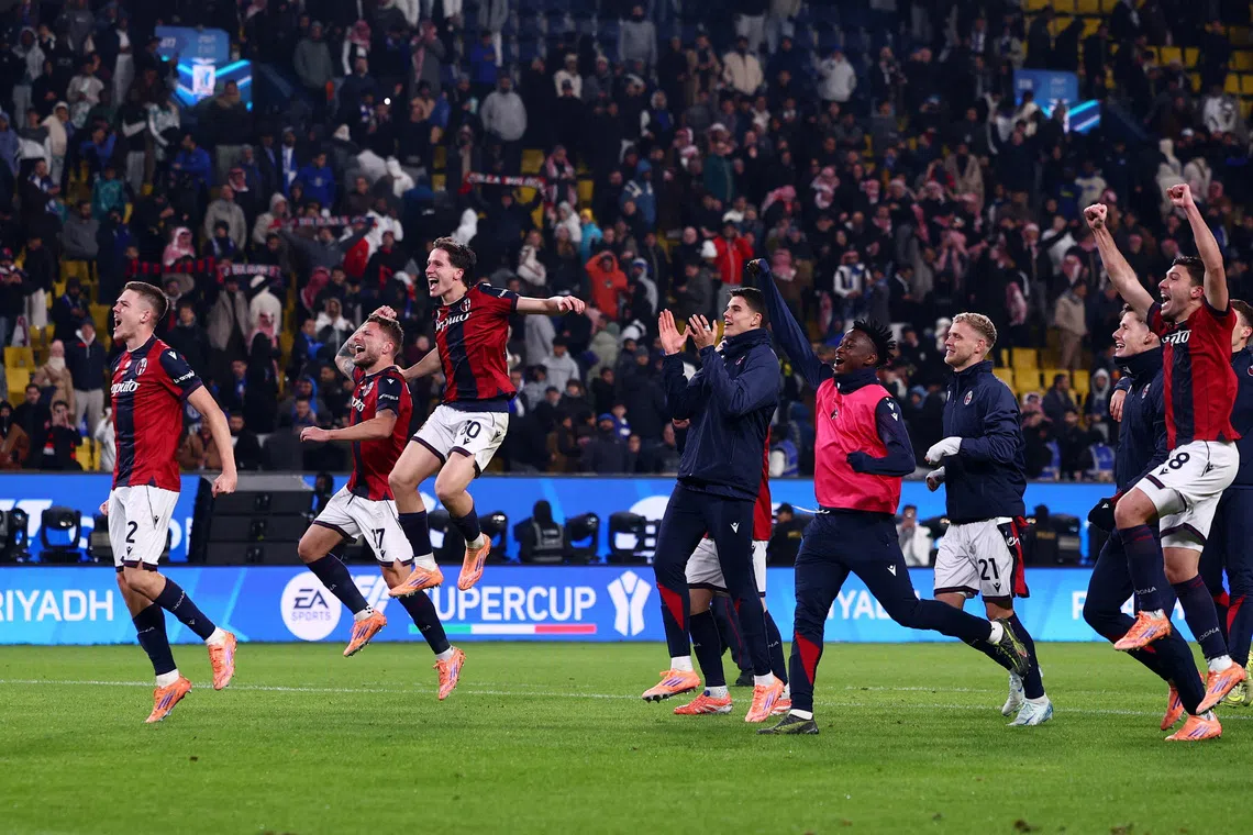 Soccer Football - Supercoppa Italiana - Semi Final - Bologna v Inter Milan - Al Awwal Park, Riyadh, Saudi Arabia - December 20, 2025 Bologna's Emil Holm, Ciro Immobile, Giovanni Fabbian with teammates celebrate after the match REUTERS/Guglielmo Mangiapane