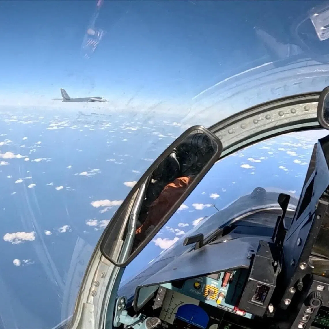 A Russian Tu-95MS strategic bomber flies over neutral waters in the Sea of Japan, as seen from the cockpit of a Russian aircraft.