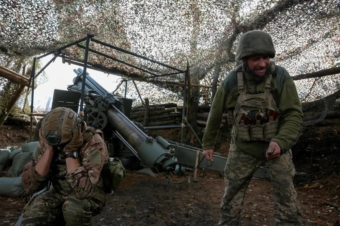 Artillerymen of the 152nd Separate Jaeger Brigade firing an M114 self-propelled howitzer towards Russian troops, near the front-line town of Pokrovsk in Ukraine's Donetsk region, on Oct 15.