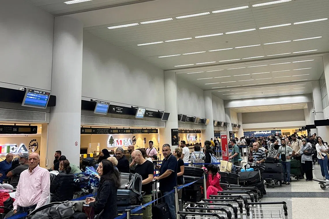 Passengers queue at the check-in counters at Beirut-Rafic Al Hariri International Airport, in Beirut, Lebanon October 2, 2024. REUTERS/Yara Abi Nader
