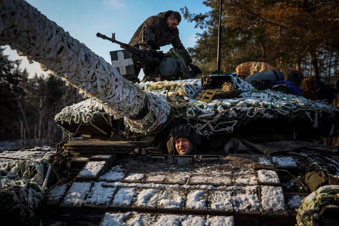 Members of a Ukrainian tank crew prepare their tank for operation in Ukraine's Donetsk region, on Feb 22, 2023.