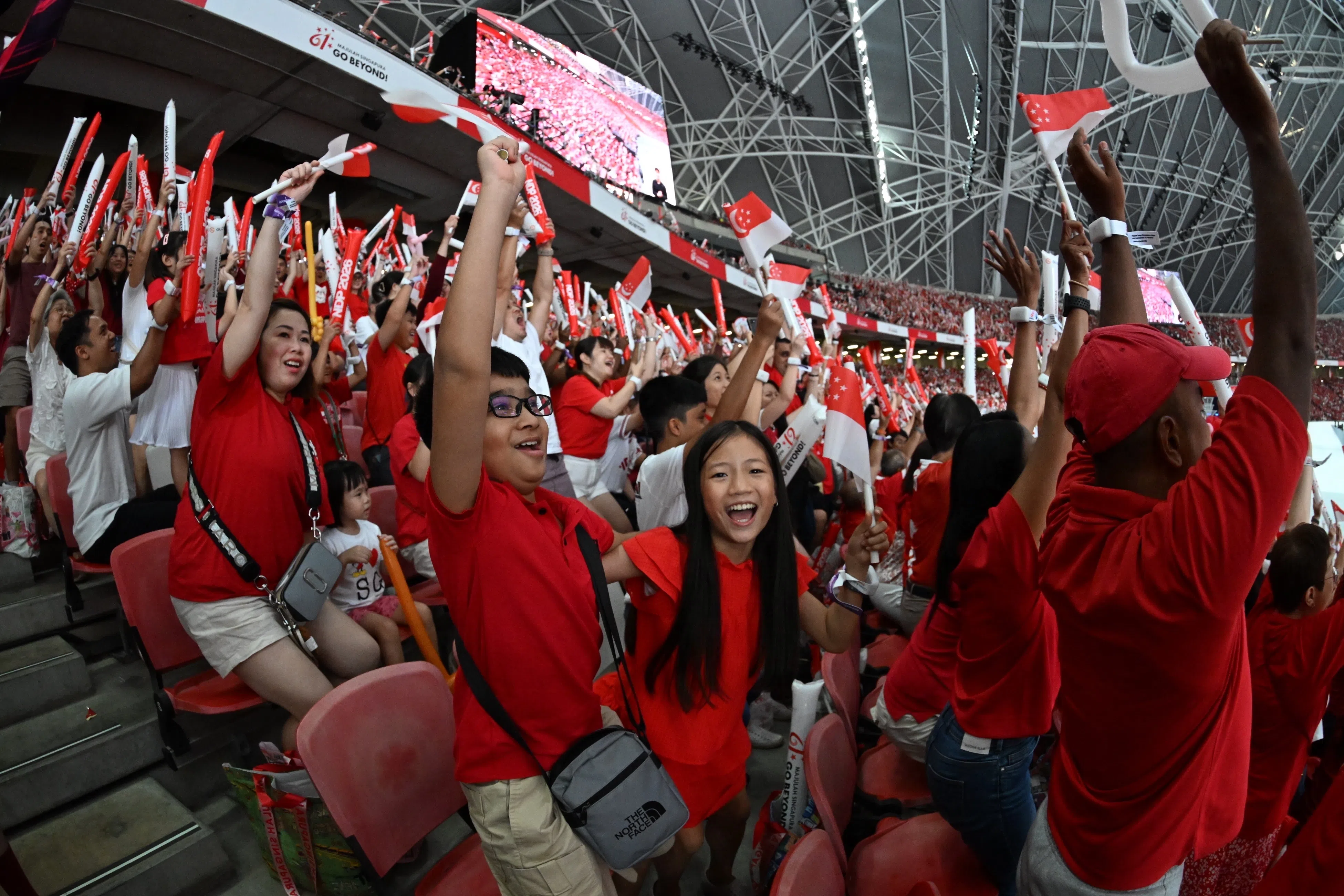 The spectators doing the Kallang wave at the National Day Parade 2026 at the National Stadium on Aug 9, 2026. ST PHOTO: Chong Jun Liang