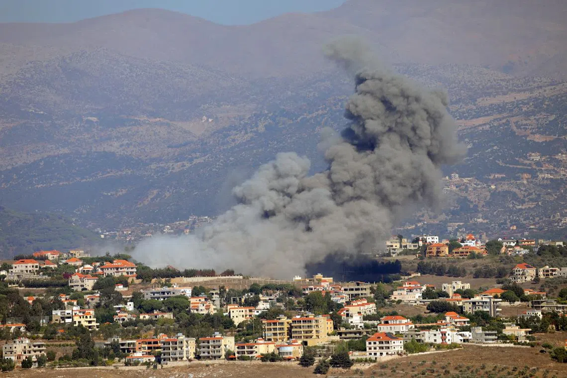 Smoke billows over Khiam, amid ongoing cross-border hostilities between Hezbollah and Israeli forces, as seen from Marjayoun, near the border with Israel, September 25, 2024. REUTERS/Karamallah Daher