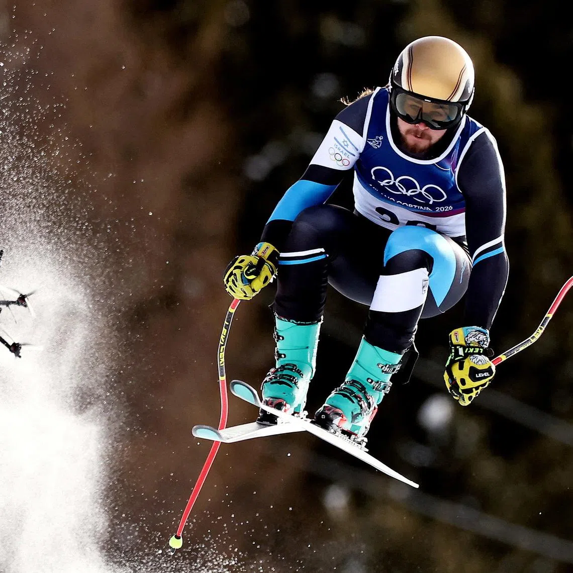 FILE PHOTO: Milano Cortina 2026 Olympics - Alpine Skiing - Men's Downhill - Stelvio Ski Centre, Bormio, Italy - February 07, 2026. Barnabas Szollos of Israel in action during the Men's Downhill as a drone is seen REUTERS/Christian Hartmann/File Photo