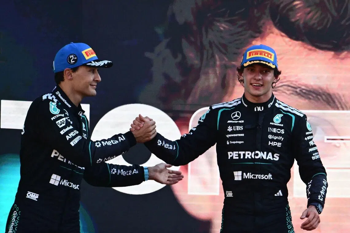 British driver George Russell (left) congratulates his Mercedes teammate Kimi Antonelli after the Italian won his home Formula 1 Grand Prix in Monza on Sept 6.