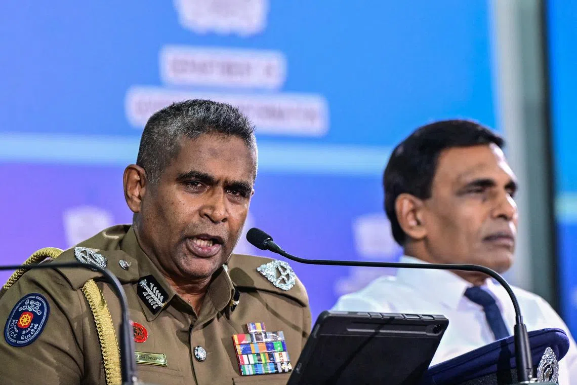Sri Lanka's Inspector-General of Police Priyantha Weerasooriya (left) speaking at a press conference in Colombo on Aug 28.