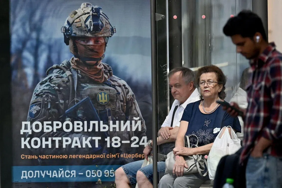 A recruitment poster for the Ukrainian Armed Forces at a bus stop in Kyiv.