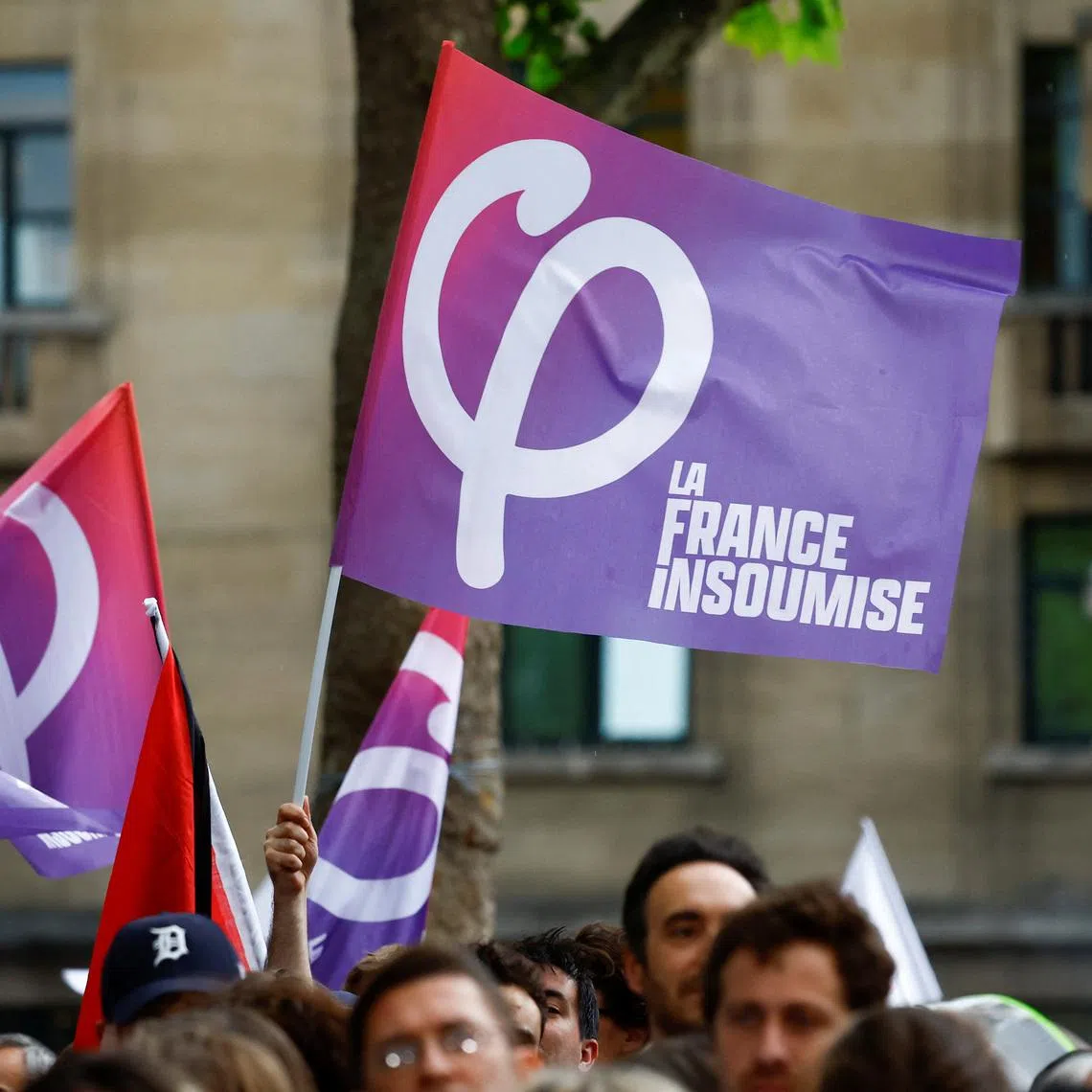 FILE PHOTO: A person holds a flag of the French far-left opposition party La France Insoumise (France Unbowed - LFI) party during a political rally by the alliance of left-wing parties in Montreuil, near Paris, on the first day of official campaigning for the upcoming French parliamentary elections, France, June 17, 2024.  REUTERS/Sarah Meyssonnier/ File Photo