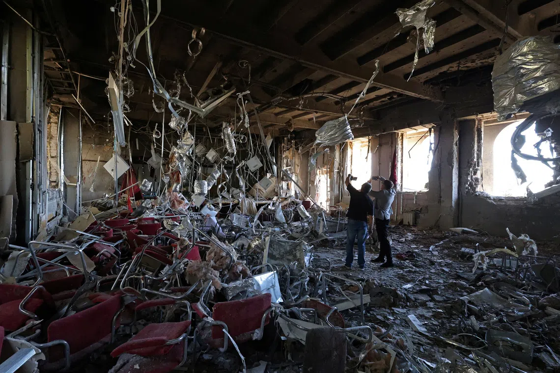 Local officials taking pictures inside a school building that was damaged yesterday in what local authorities called a Ukrainian drone attack in the course of Russia-Ukraine conflict, in the town of Foros, Crimea on Sept 22, 2025. 