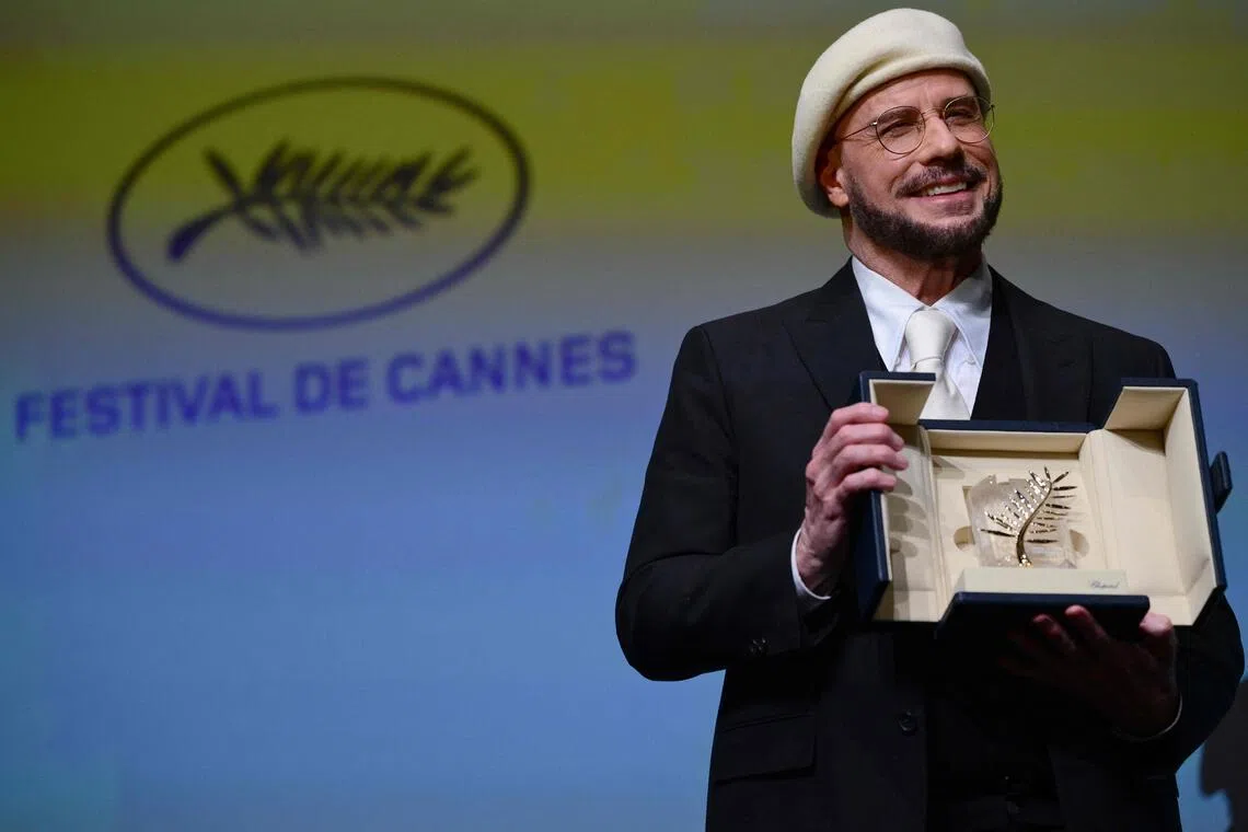 John Travolta receives an honorary Palm d'Or award prior to the screening of his film Propeller One-Way Night Coach at the Cannes Film Festival in Cannes, France on May 15.