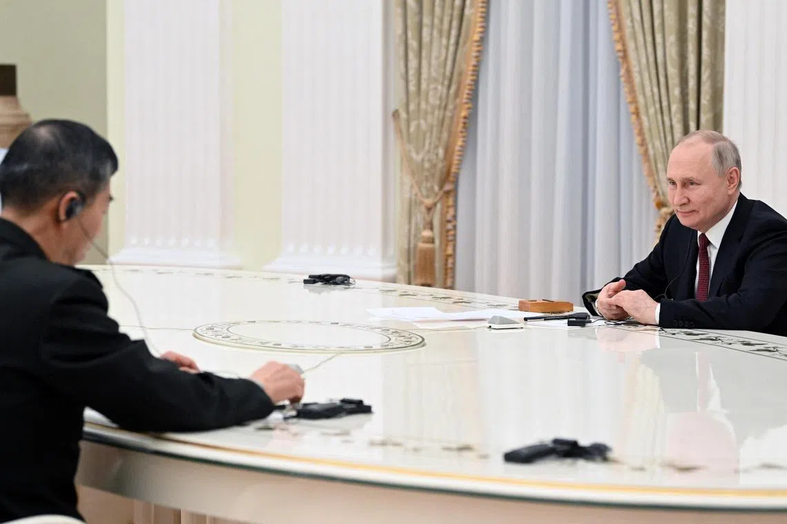 Russian President Vladimir Putin (right) hosts a meeting with Chinese Defence Minister Li Shangfu in Moscow.