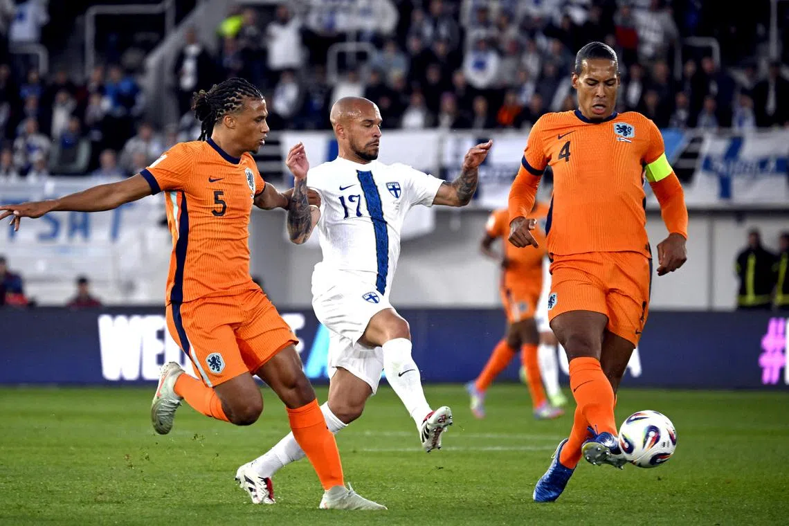 FILE PHOTO: Soccer Football - World Cup - European Qualifiers - Group G - Finland v Netherlands - Helsinki Olympic Stadium, Helsinki, Finland - June 7, 2025 Netherlands' Nathan Ake and Virgil van Dijk in action with Finland's Nikolai Alho  MARKKU ULANDER/Lehtikuva via REUTERS/File Photo