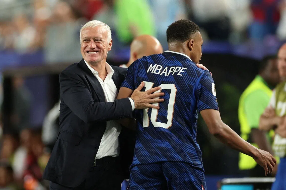 France coach Didier Deschamps embraces Kylian Mbappe as he leaves the pitch after being substituted during their game against Iraq.