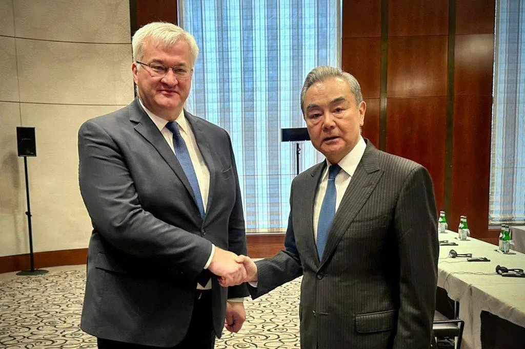 Ukrainian Foreign Minister Andrii Sybiha (left) meeting Chinese Foreign Minister Wang Yi on the sidelines of the Munich Security Conference, in Munich, Germany, on Feb 13.