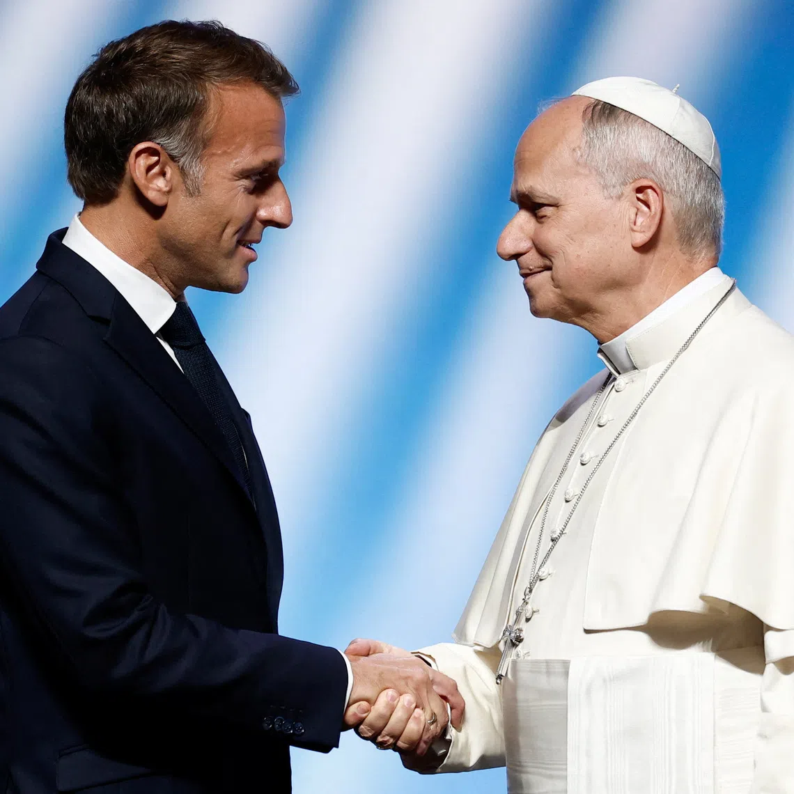French President Emmanuel Macron shakes hands with Pope Leo at a meeting titled \"At the Roots of Europe for Peace and Unity\" at the Robert Schuman convention centre, in Metz, as part of Pope Leo's four-day apostolic journey to France, September 28, 2026. REUTERS/Benoit Tessier/Pool