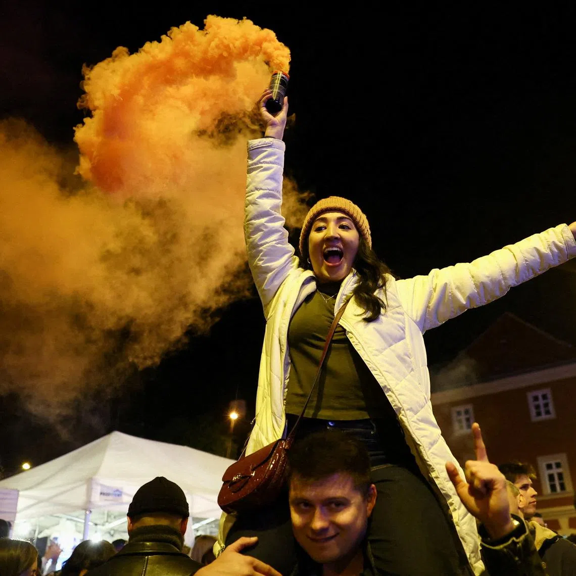 People celebrate following partial results on the day of the Hungarian Parliamentary election in Budapest, Hungary, April 13, 2026. REUTERS/Bernadett Szabo