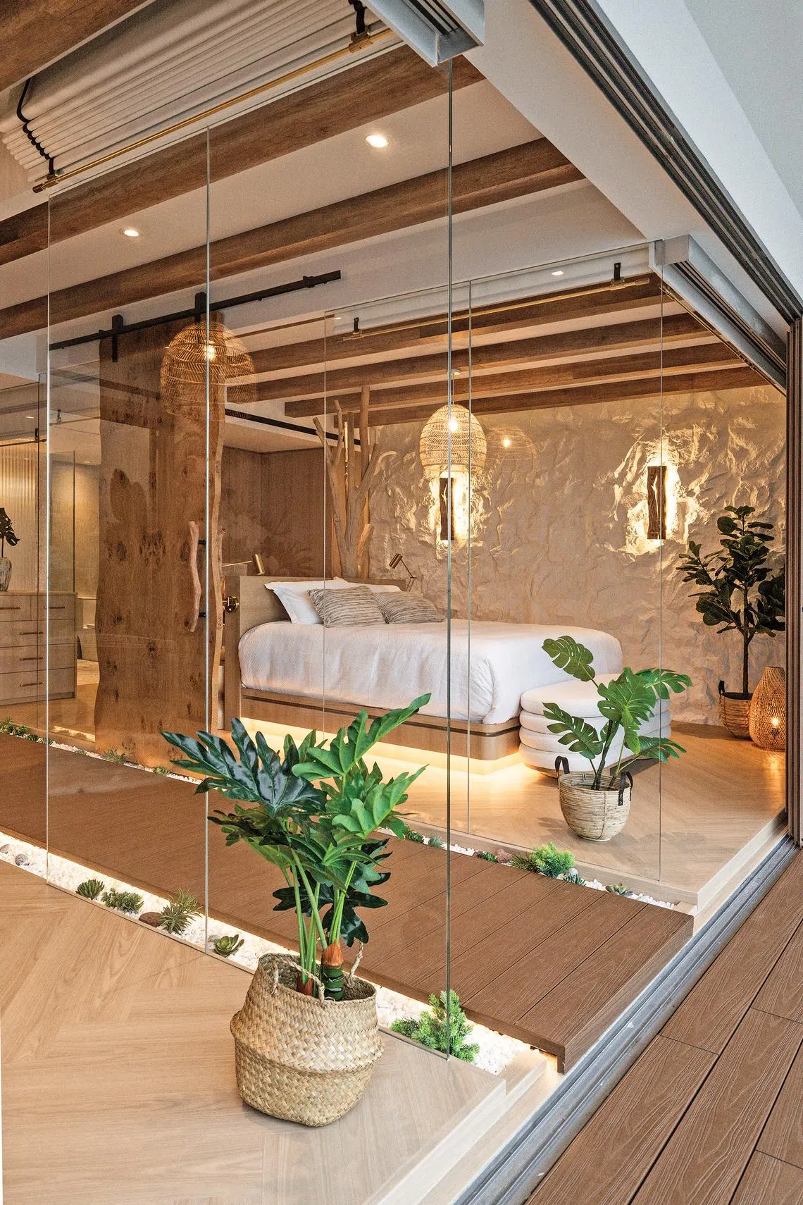 The master bedroom has glass walls, with Roman blinds that can be lowered for privacy.