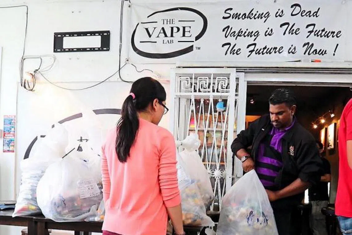 Malaysian authorities taking away seized vape liquids and related products in a joint raid at an outlet in Johor Baru. The crackdown on vape sellers in Malaysia has begun, starting with those selling nicotine-laced liquids, ahead of the Jan 1 ban on vapes in the state. Police, aided by state and federal agencies, raided three outlets, two in Taman Century and one in Larkin, seizing RM380,385 worth of products. Nicotine is listed in the Poisons Act and products containing it can only be sold by pharmacists.