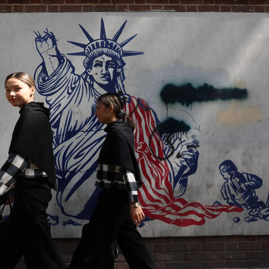 People walk near an anti-U.S. mural in Tehran, Iran, June 30, 2026. Majid Asgaripour/WANA (West Asia News Agency) via REUTERS ATTENTION EDITORS - THIS PICTURE WAS PROVIDED BY A THIRD PARTY. ATTENTION EDITORS - THIS PICTURE WAS PROVIDED BY A THIRD PARTY.   ATTENTION EDITORS - THIS PICTURE WAS PROVIDED BY A THIRD PARTY. ISRAEL OUT. NO COMMERCIAL OR EDITORIAL SALES IN ISRAEL. NO ACCESS FOR ISRAELI MEDIA. NO USE BBC PERSIAN. NO USE VOA PERSIAN. NO USE MANOTO. NO USE IRAN INTERNATIONAL. NO USE RADIO FARDA. DIGITAL: NO USE BBC PERSIAN. NO USE VOA PERSIAN. NO USE MANOTO. NO USE IRAN INTERNATIONAL. NO USE RADIO FARDA.