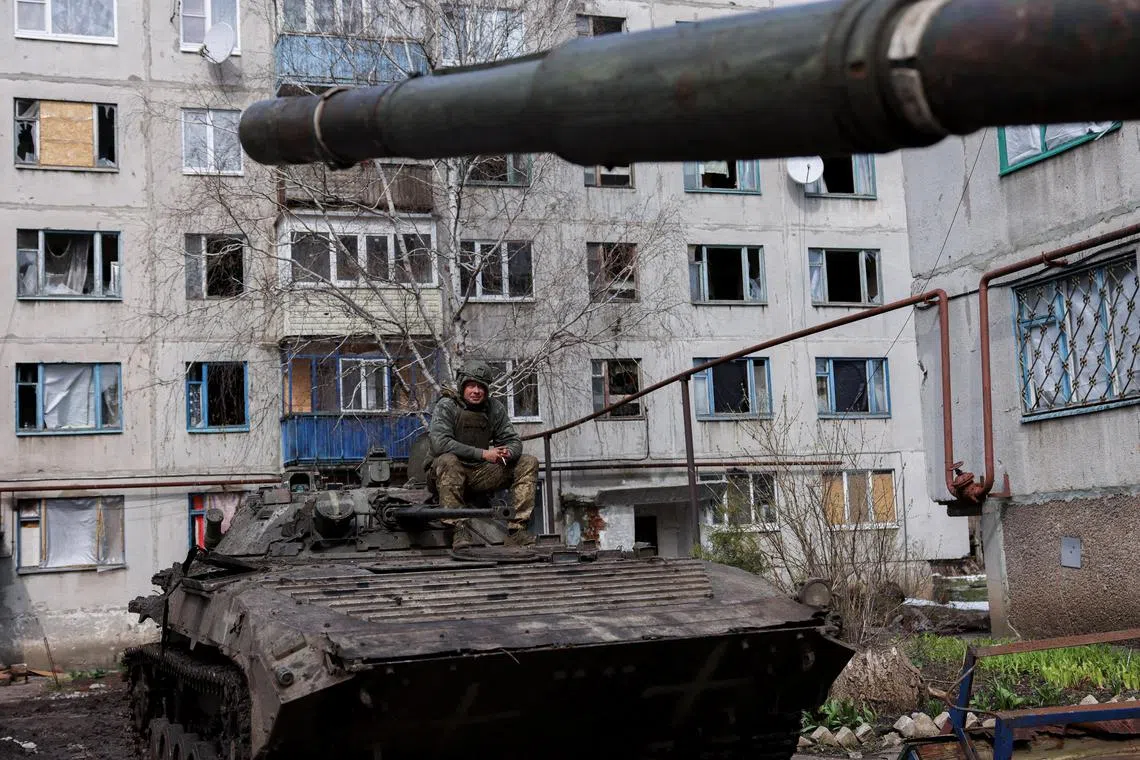 An Ukrainian serviceman sits atop an infantry fighting vehicle (IFV), amid Russia's invasion of Ukraine, near the bombed-out eastern city of Bakhmut, in the eastern Donetsk region, Ukraine, April 2, 2023. REUTERS/Violeta Santos Moura