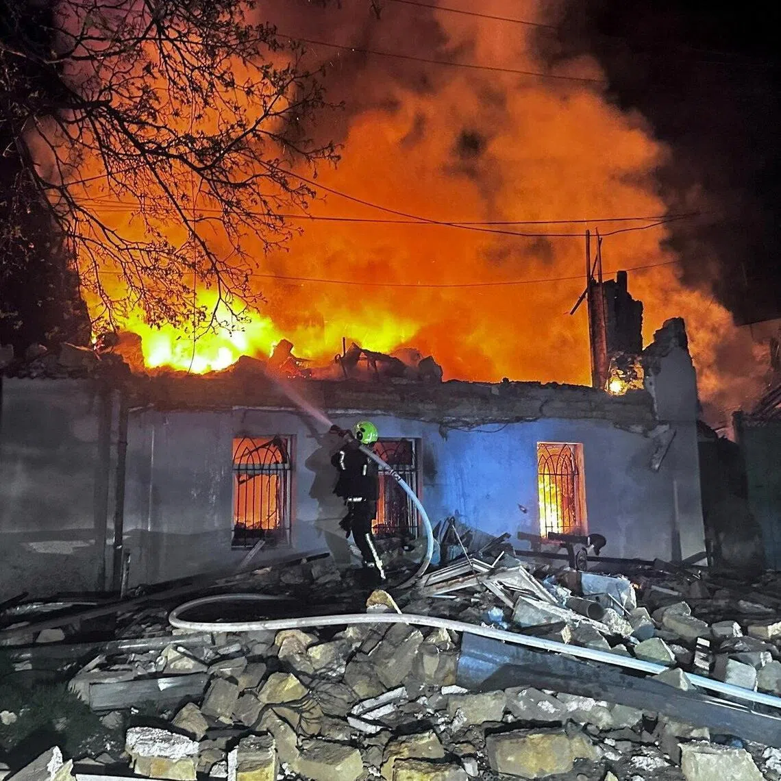 A firefighter working at the site of a residential building hit by Russian drone strikes overnight on April 11., in Odesa, Ukraine.