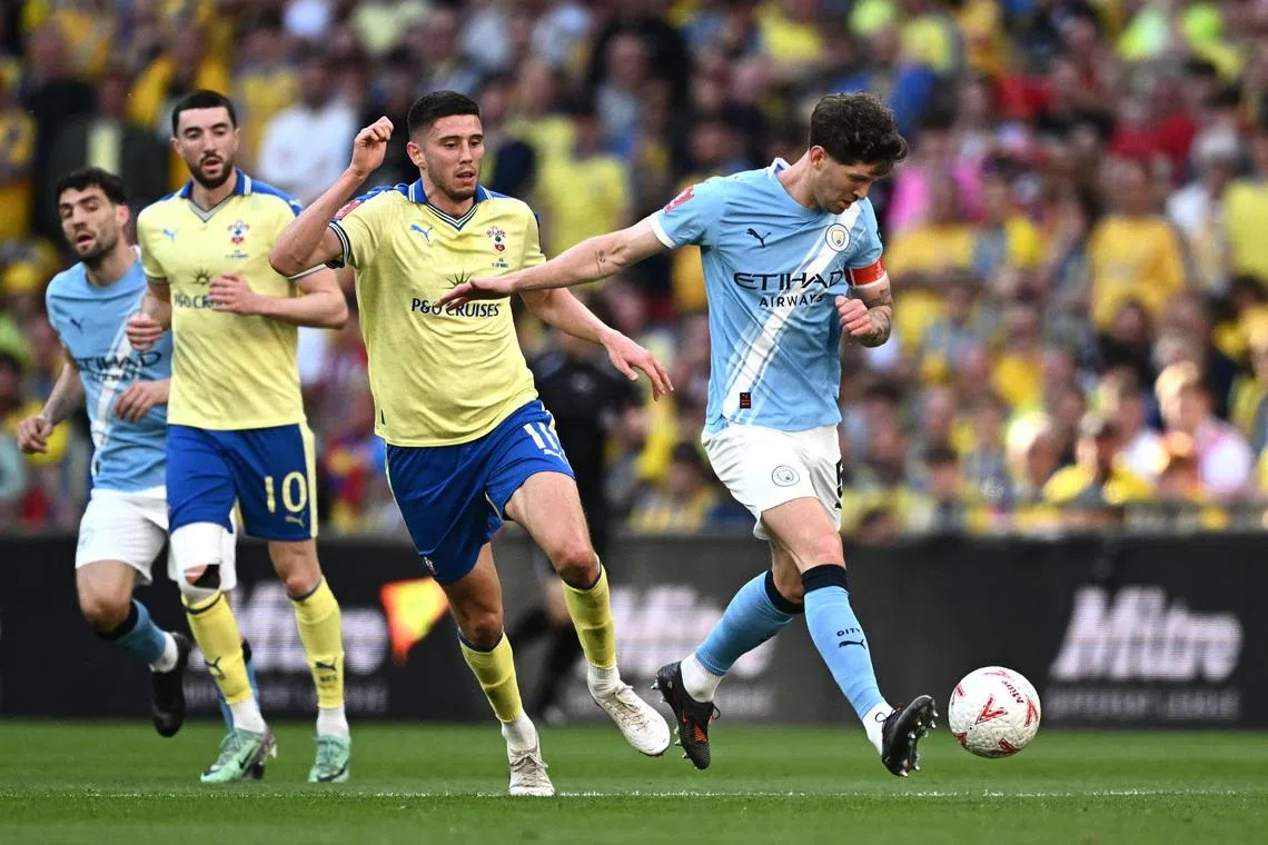 FILE PHOTO: Soccer Football - FA Cup - Semi Final - Manchester City v Southampton - Wembley Stadium, London, Britain - April 25, 2026 Manchester City's John Stones in action with Southampton's Ross Stewart REUTERS/Dylan Martinez/File Photo