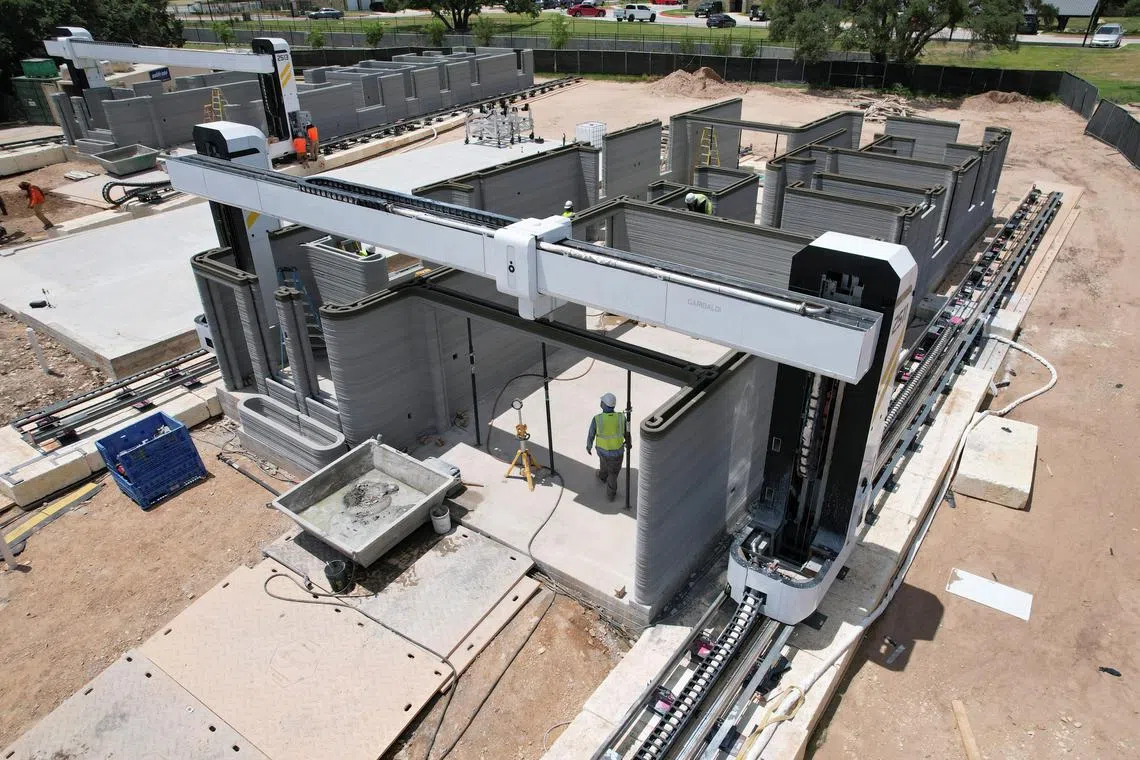 A drone image shows a 3D printer printing the walls of a home under construction in Georgetown, Texas on June 30. 