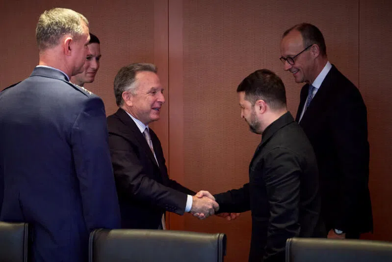 Germany's Chancellor Friedrich Merz (right) and US President Donald Trump's son-in-law Jared Kushner (second from left) react as US special envoy Steve Witkoff (centre) and Ukraine's President Volodymyr Zelensky greet each other prior to the meeting in Berlin.