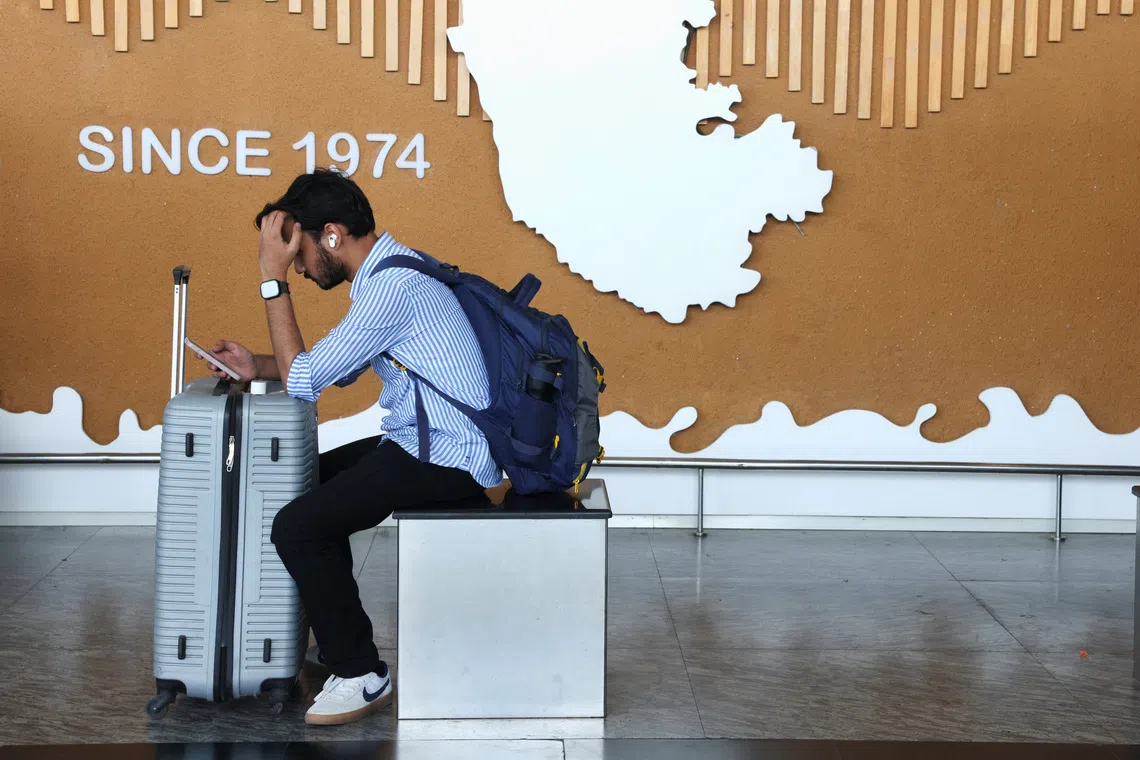 A traveller uses his mobile phone at Kempegowda International Airport in Bengaluru, India, December 6, 2025. REUTERS/Priyanshu Singh