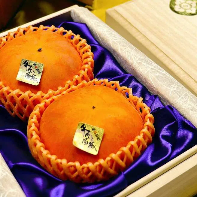 The persimmons fetched record high price of ¥1.11 million (S$9,310) for two fruits, before tax. 